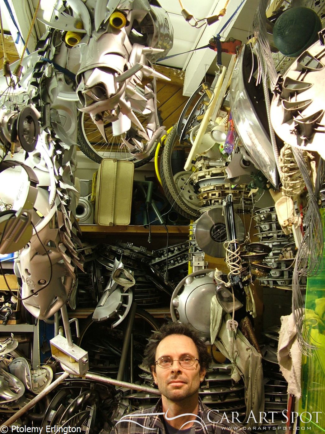 Ptolemy Erlington surrounded by his hubcap art